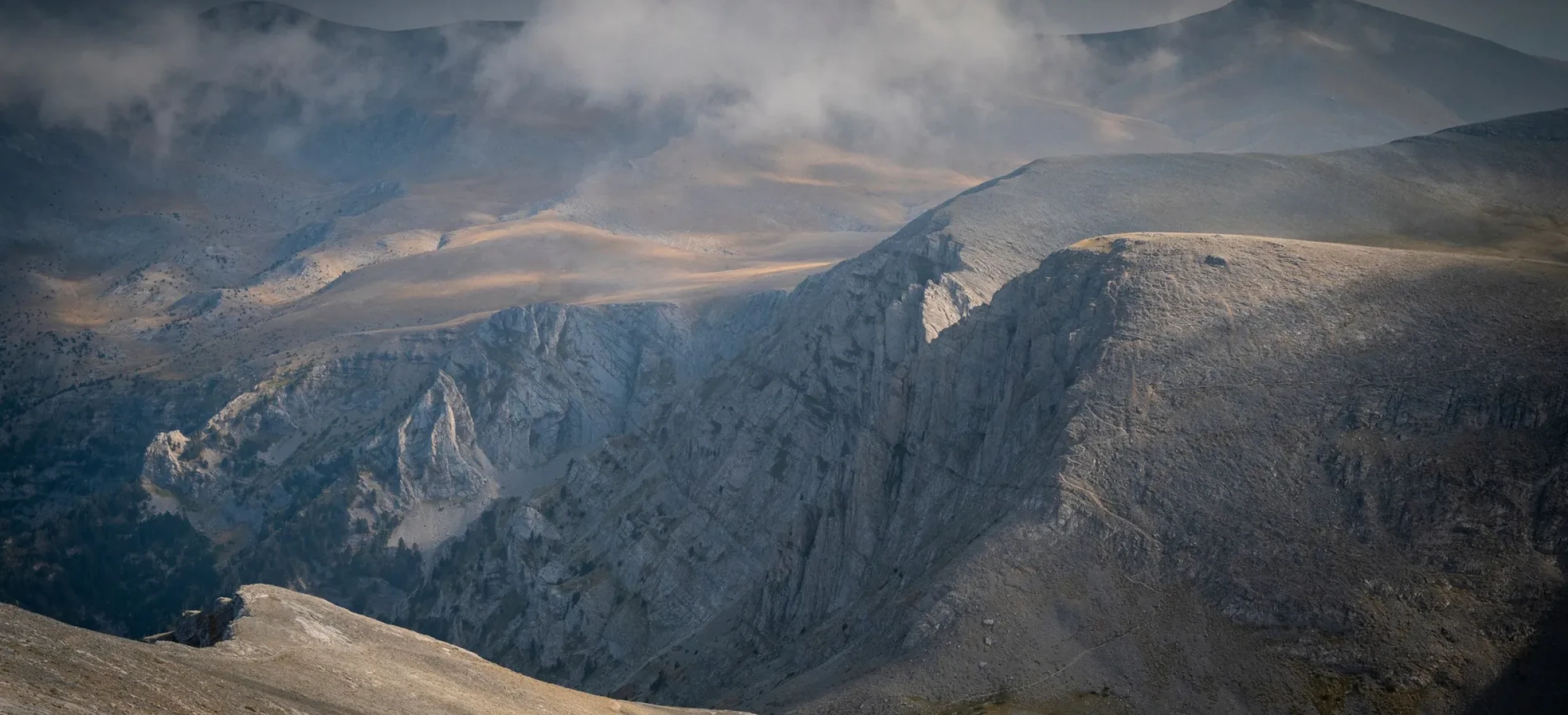 Rocky mountains and grey cloudy sky above