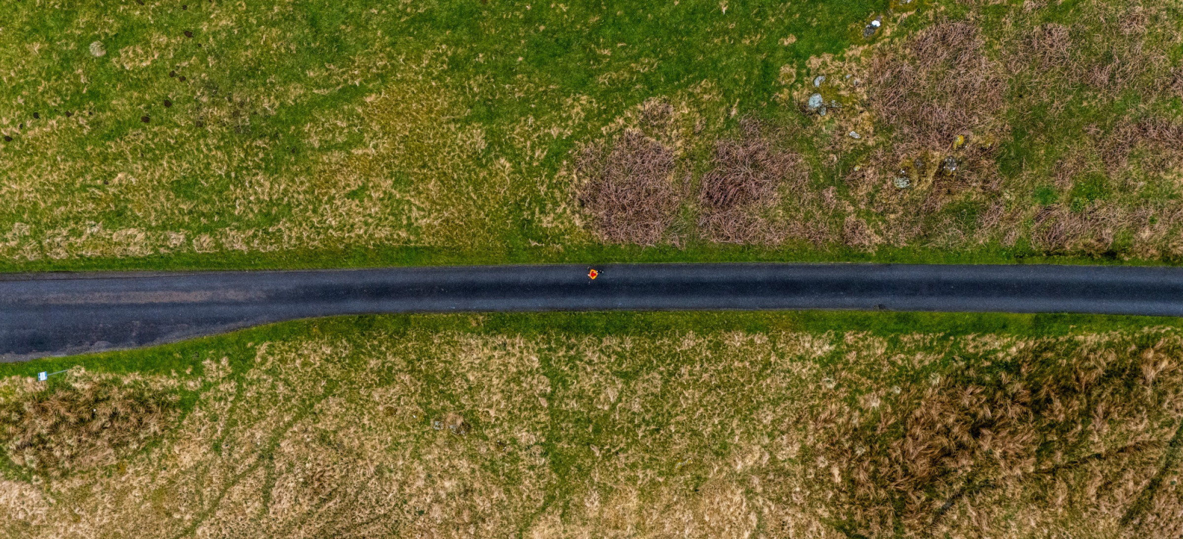 Aerial view of road with fields either side