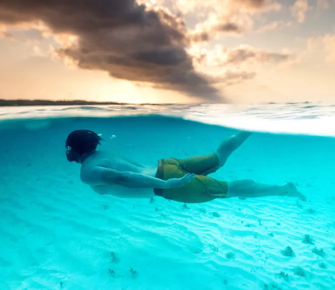 Man snorkelling through clear water