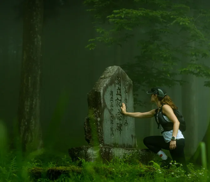 Woman touching a sign in a dense forest