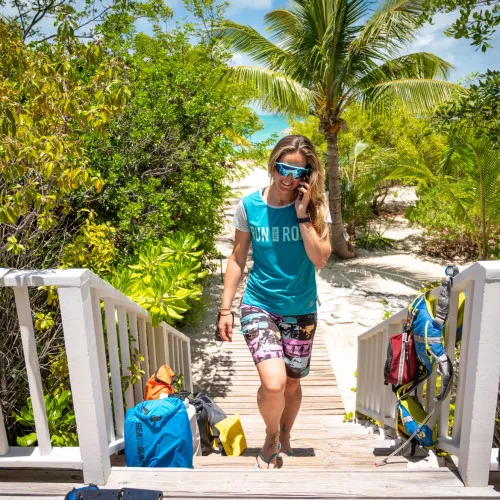 Woman walking up wooden steps on beach