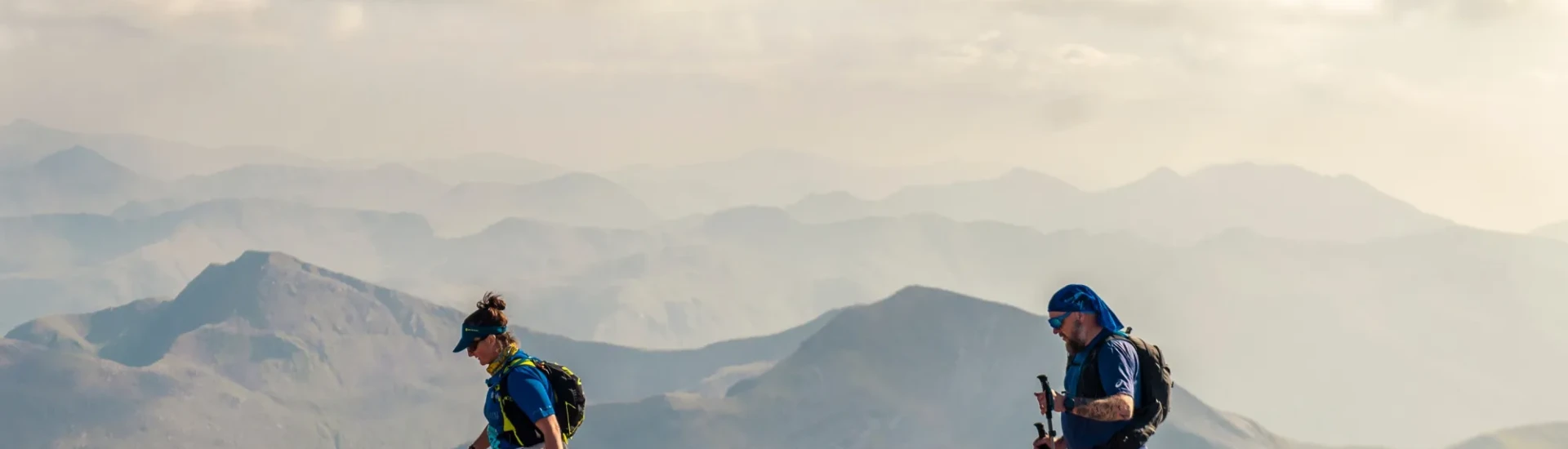 Man and woman walking on rocky terrain at high altitude