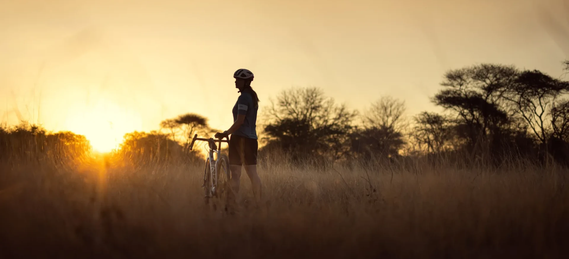 Woman stood on grass with bike