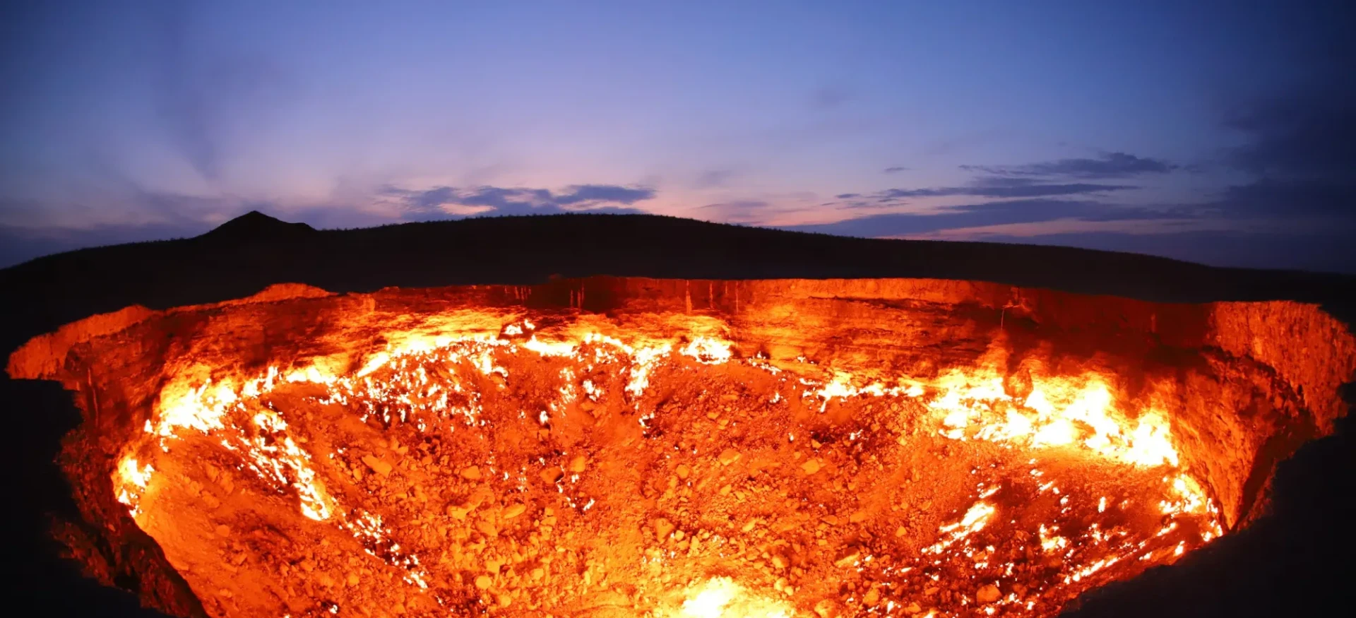 Crater in ground on fire