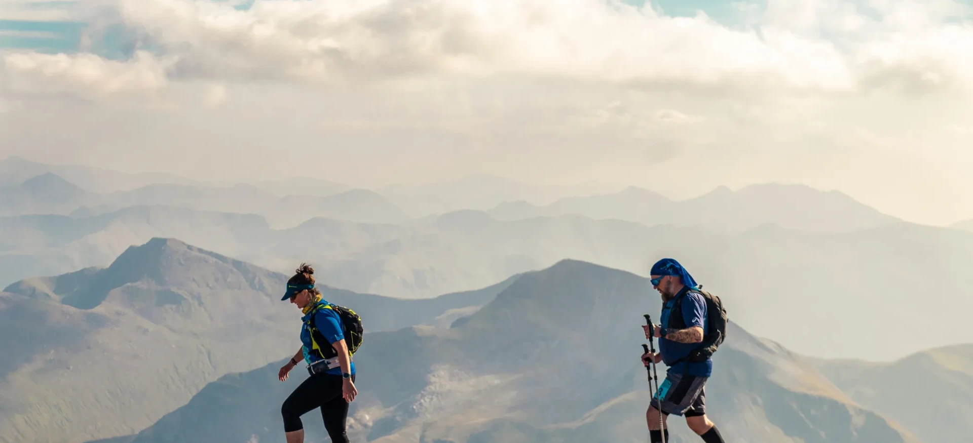Man and woman walking on rocky terrain at high altitude