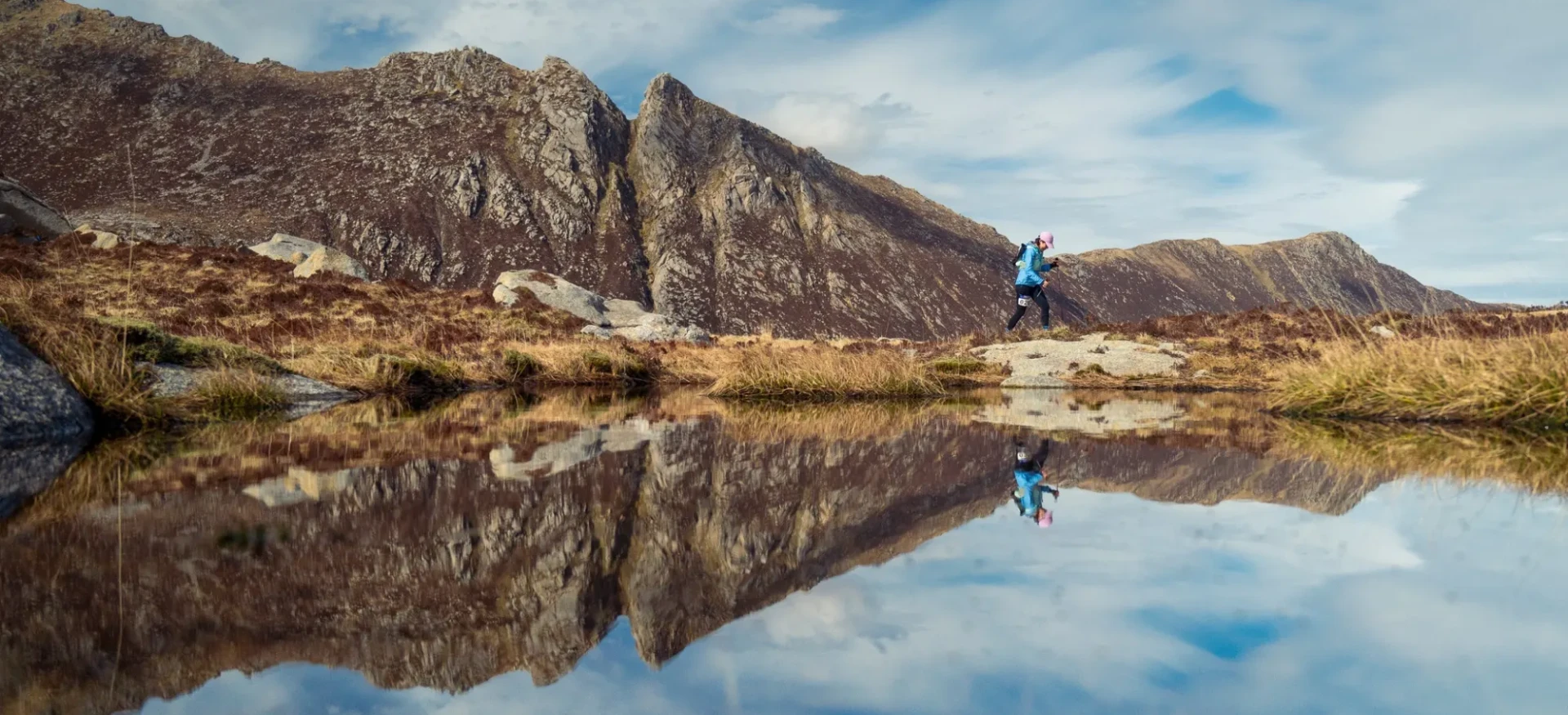 Person running along edge of clear water