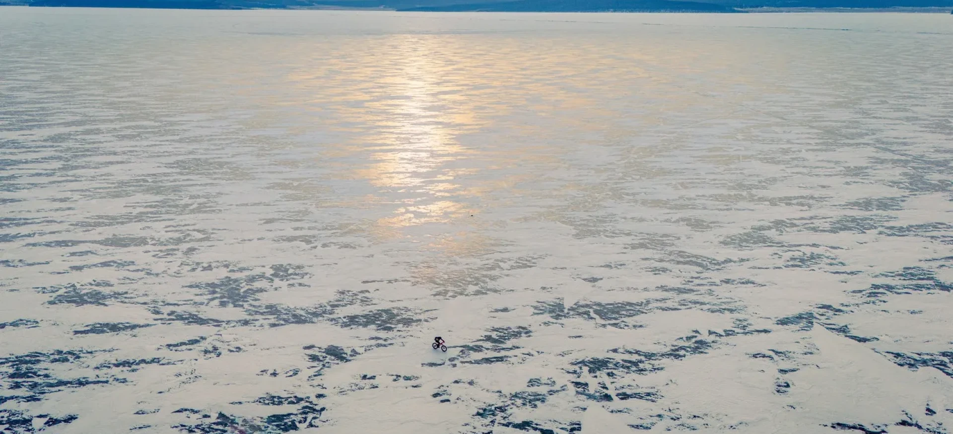 Participant cycling over frozen lake