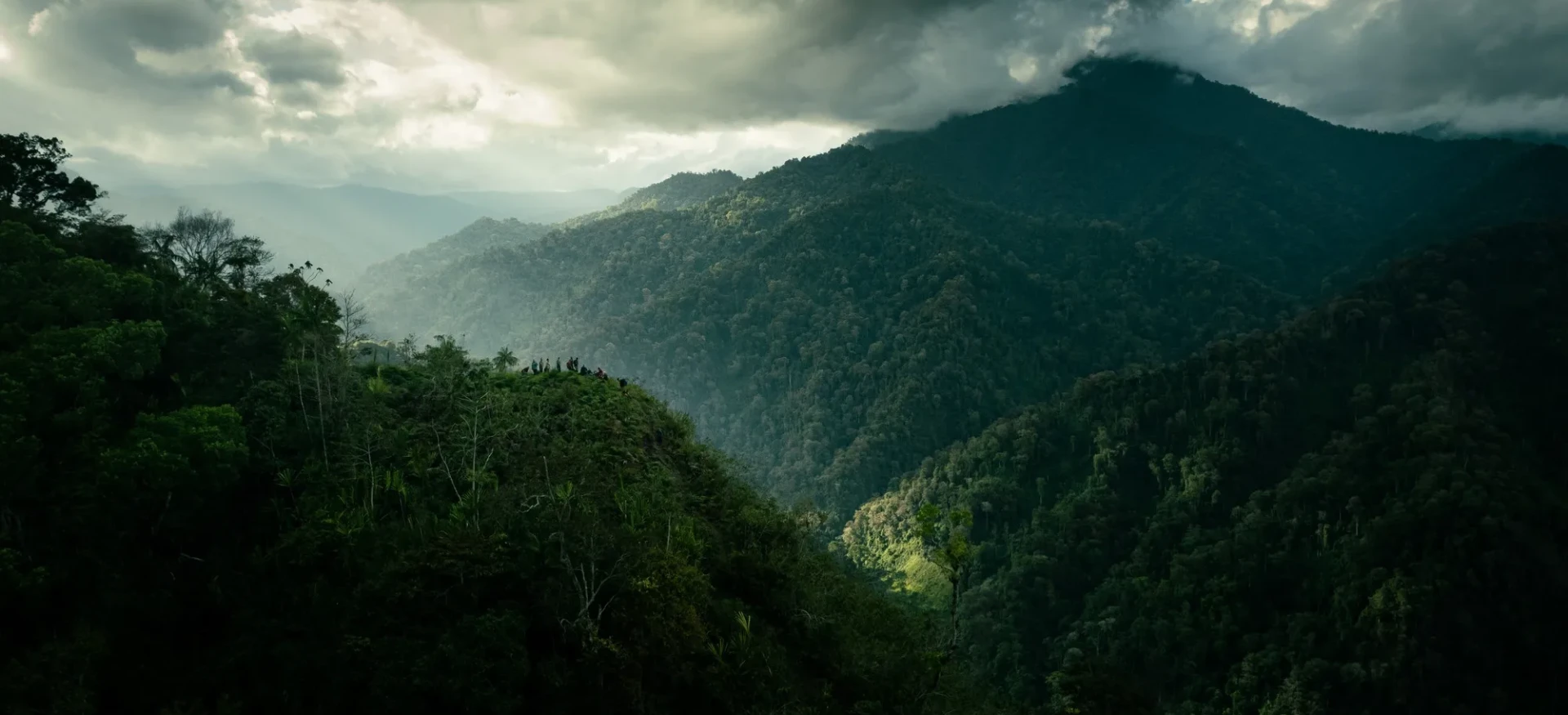 Dense mountainous jungle with grey sky above