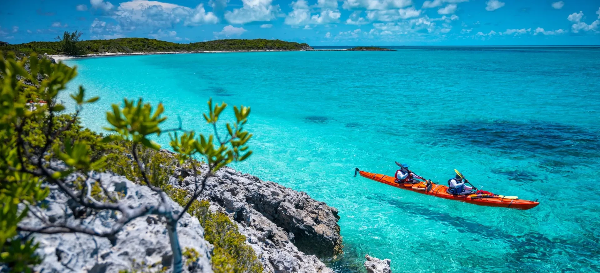 Two participants kayaking on clear waters