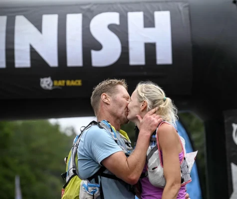Man and woman kissing at finish