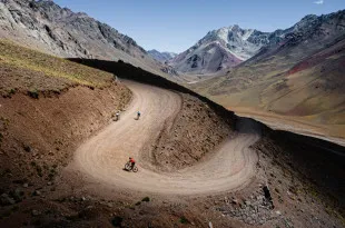 Cyclists riding along winding path