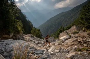 Woman running on rocky terrain