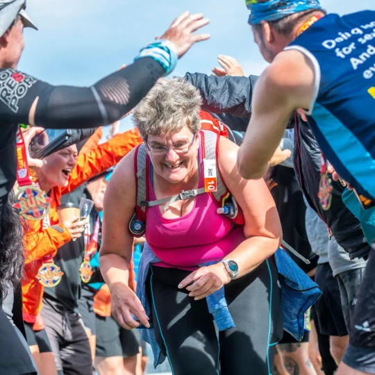 Woman smiling and running through group of people