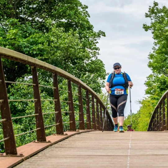 Woman walking over bridge