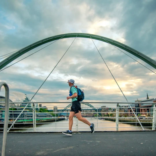 Man running across bridge in Newcastle