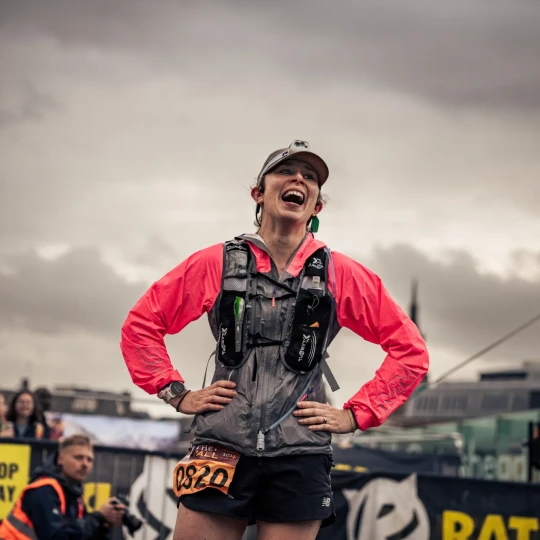 Woman smiling with grey sky above her