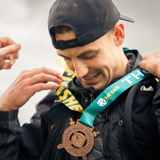 Man putting medal around his neck