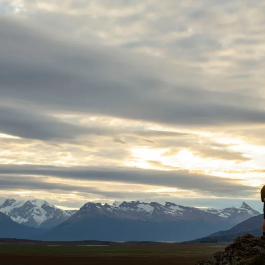 Man and woman stood on a rock and hugging