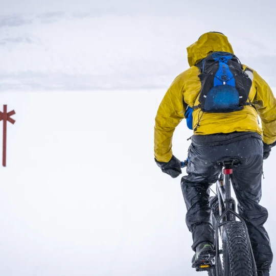 Man riding a fat bike through snow