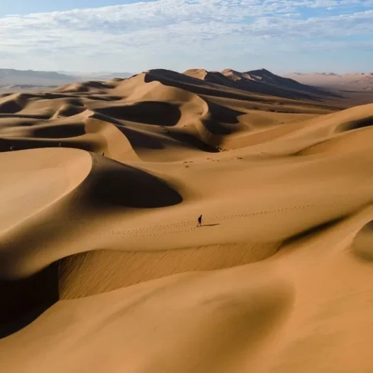 Smooth sand dunes under clear sky