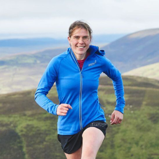 Woman smiling and running