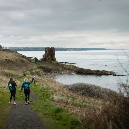 Women walking along coastal path