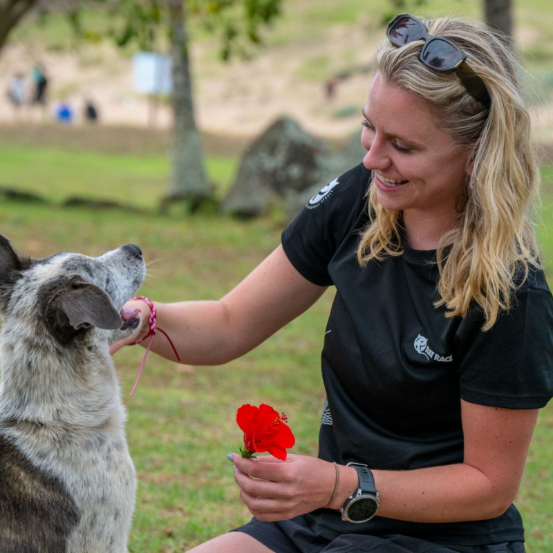 Woman smiling and stroking dog
