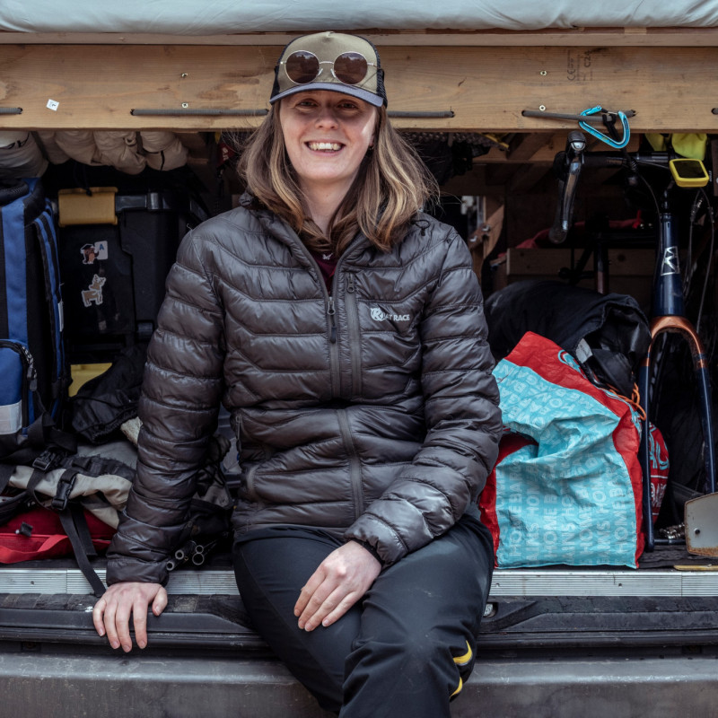 Woman sitting in camper van and smiling