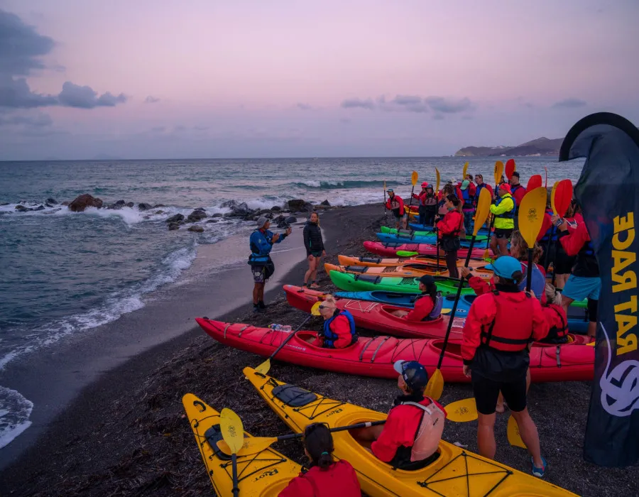 Participants standing with their kayaks