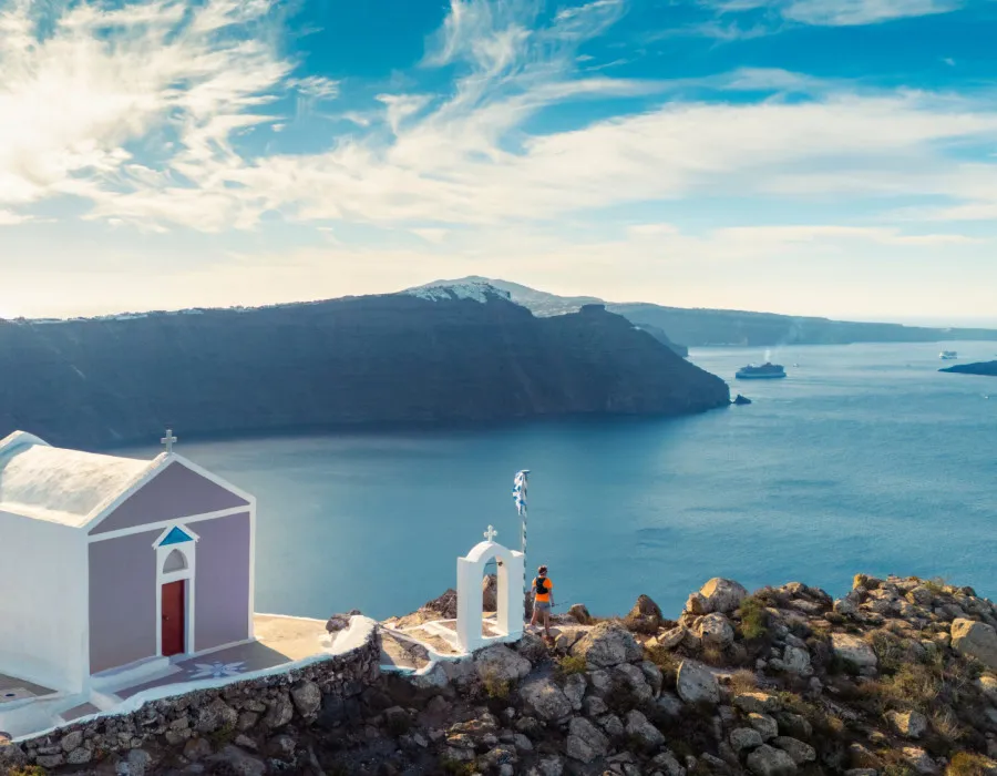White building on edge of land and sea behind