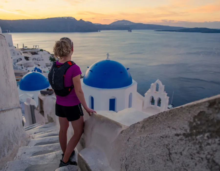 Woman stood on steps and looking out to sunset
