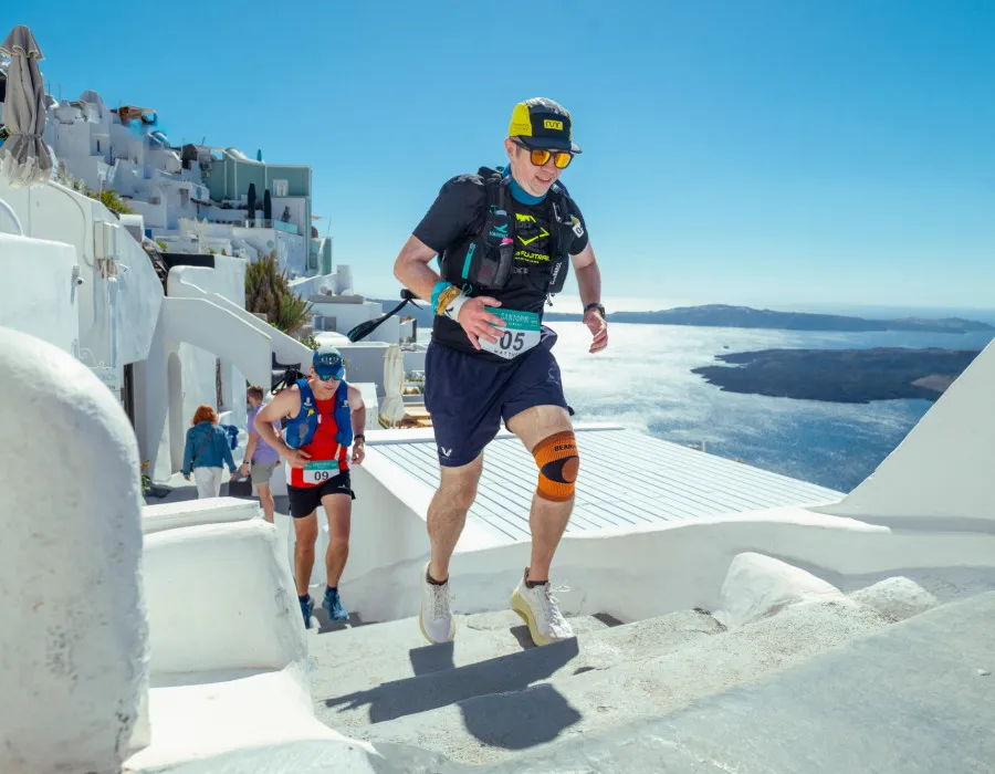 Men running up white steps
