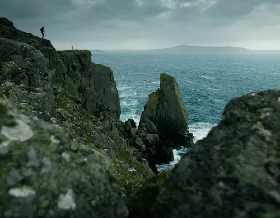 Participants stood on rocky cliffs with water below