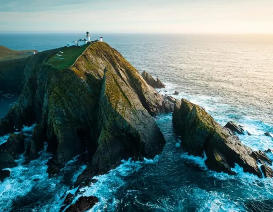 Aerial view of buildings on cliff and water below