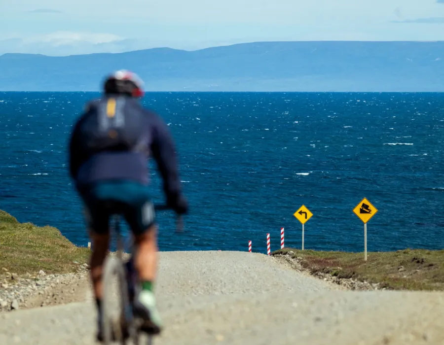 Cyclist riding along track towards water