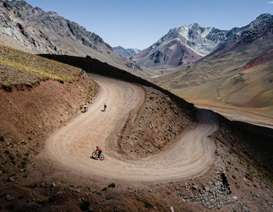 Cyclists riding along winding path