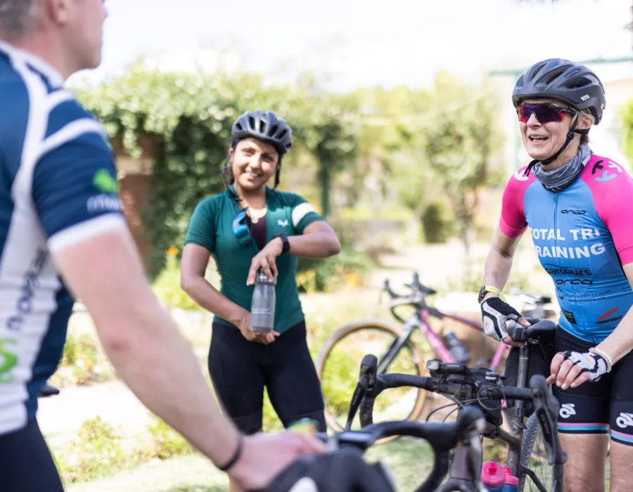 Participants stood with bikes and chatting and smiling