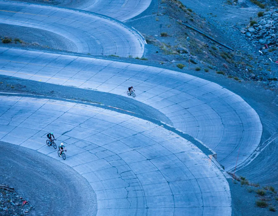 Cyclists riding along winding path