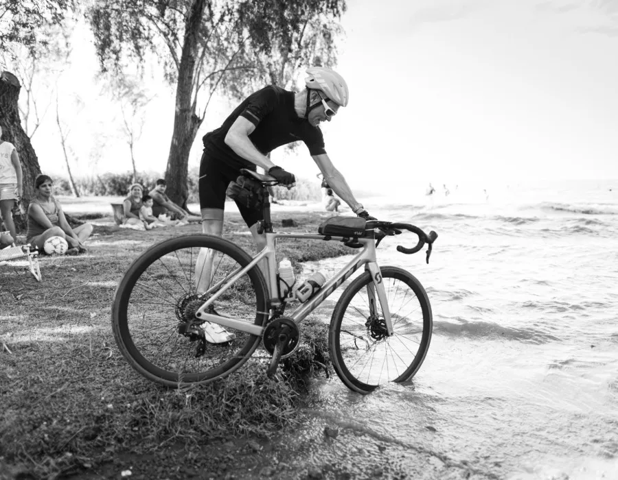 Man pushing bike into water