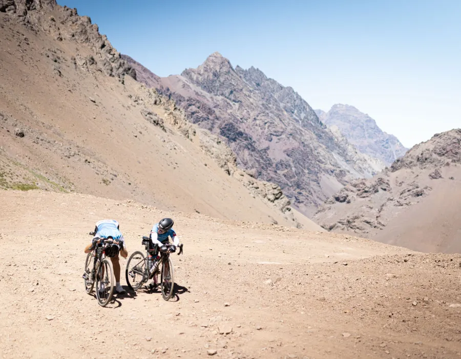 Cyclists stood infront of rocky mountains