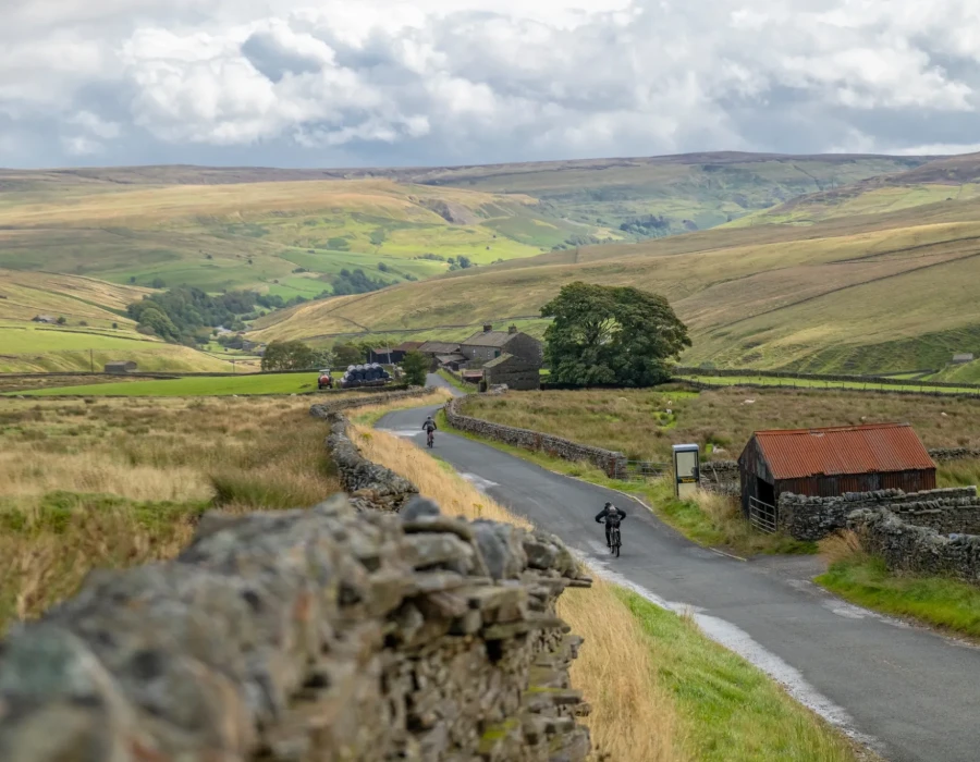 Cyclists riding along rural road