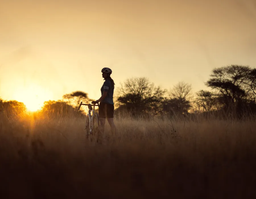 Woman stood on grass with bike