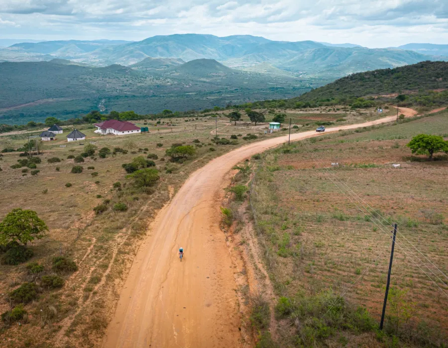 Cyclist riding along dusty road