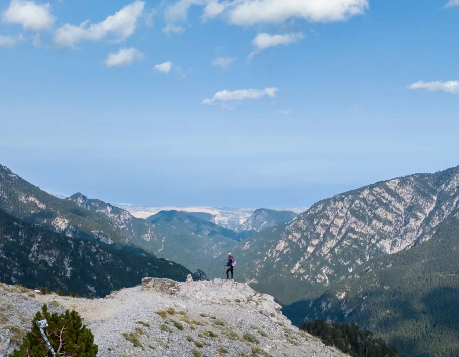 Person stood on rocky terrain with mountains behind