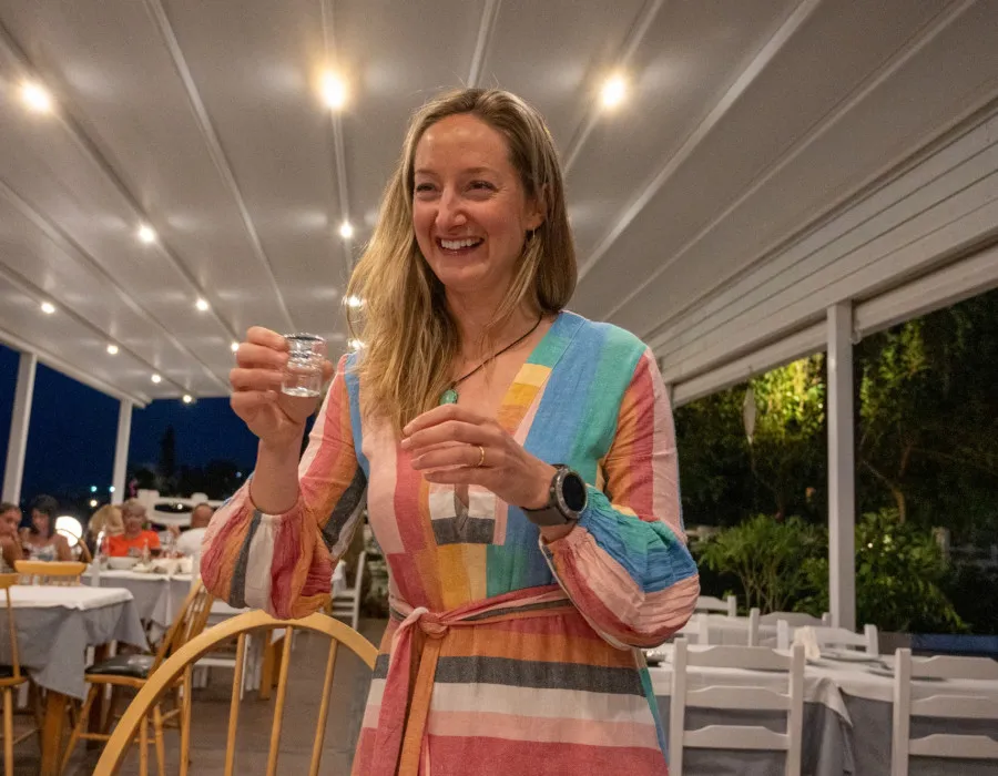 Woman holding a small glass and smiling