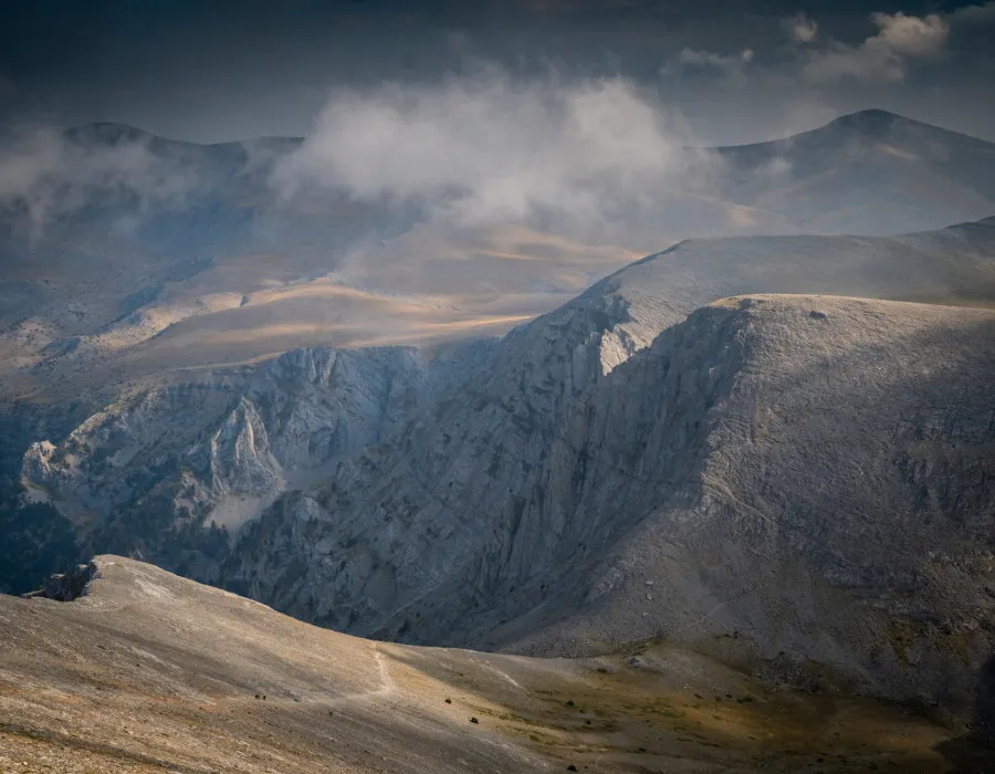 Rocky mountains and grey cloudy sky above