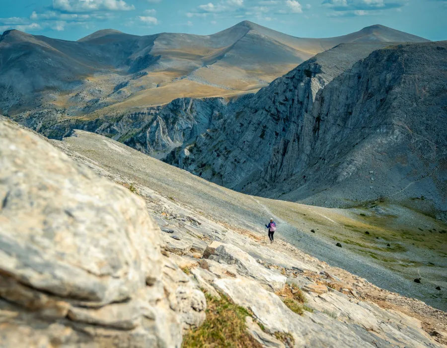 Person hiking on rocky, mountainous terrain