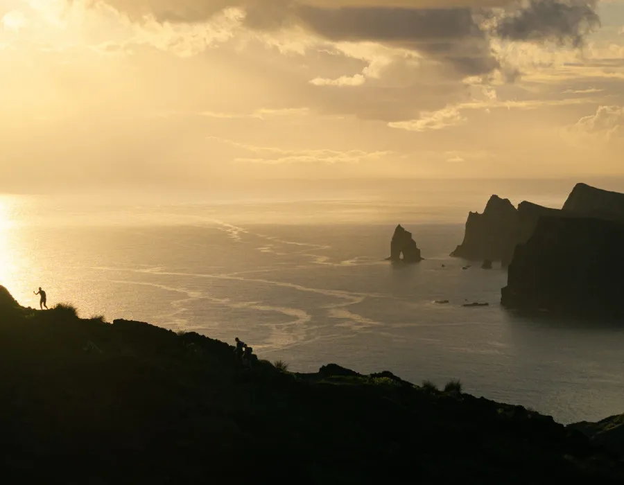 Rocky islands poking through the sea and a colourful sky above