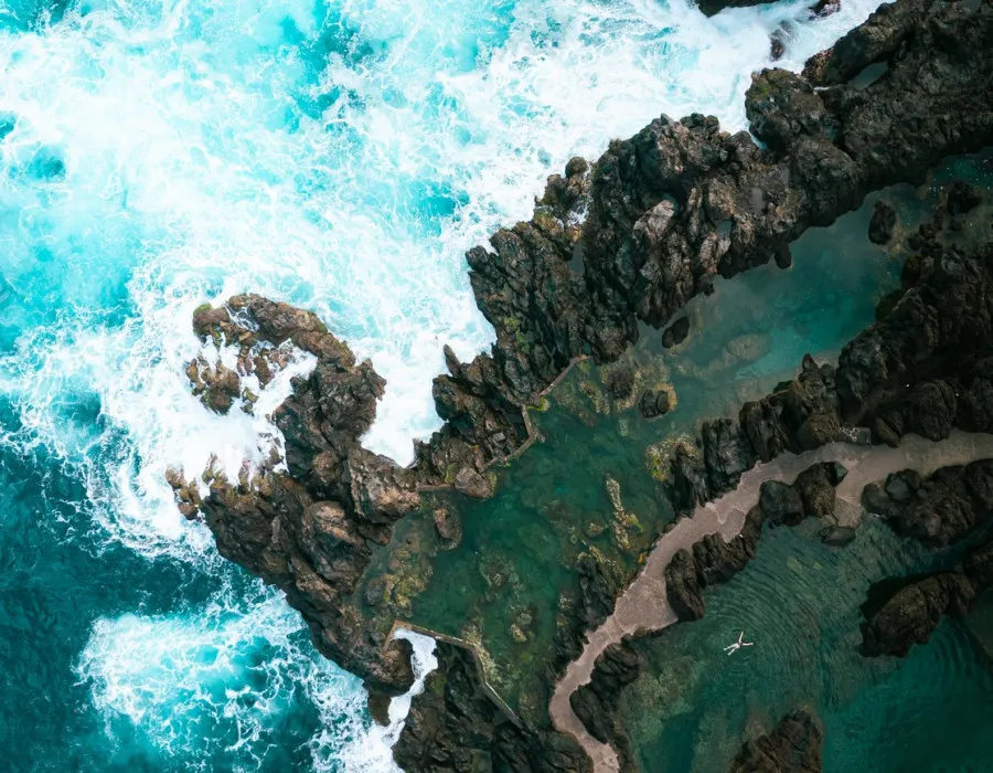 Aerial view of waves crashing against rocks
