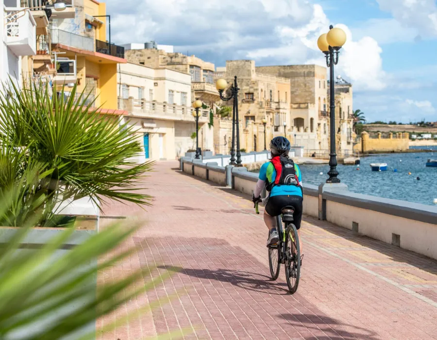 Cyclist riding through sunny town